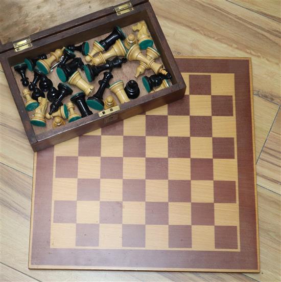 A Staunton pattern stained and natural chess set and board